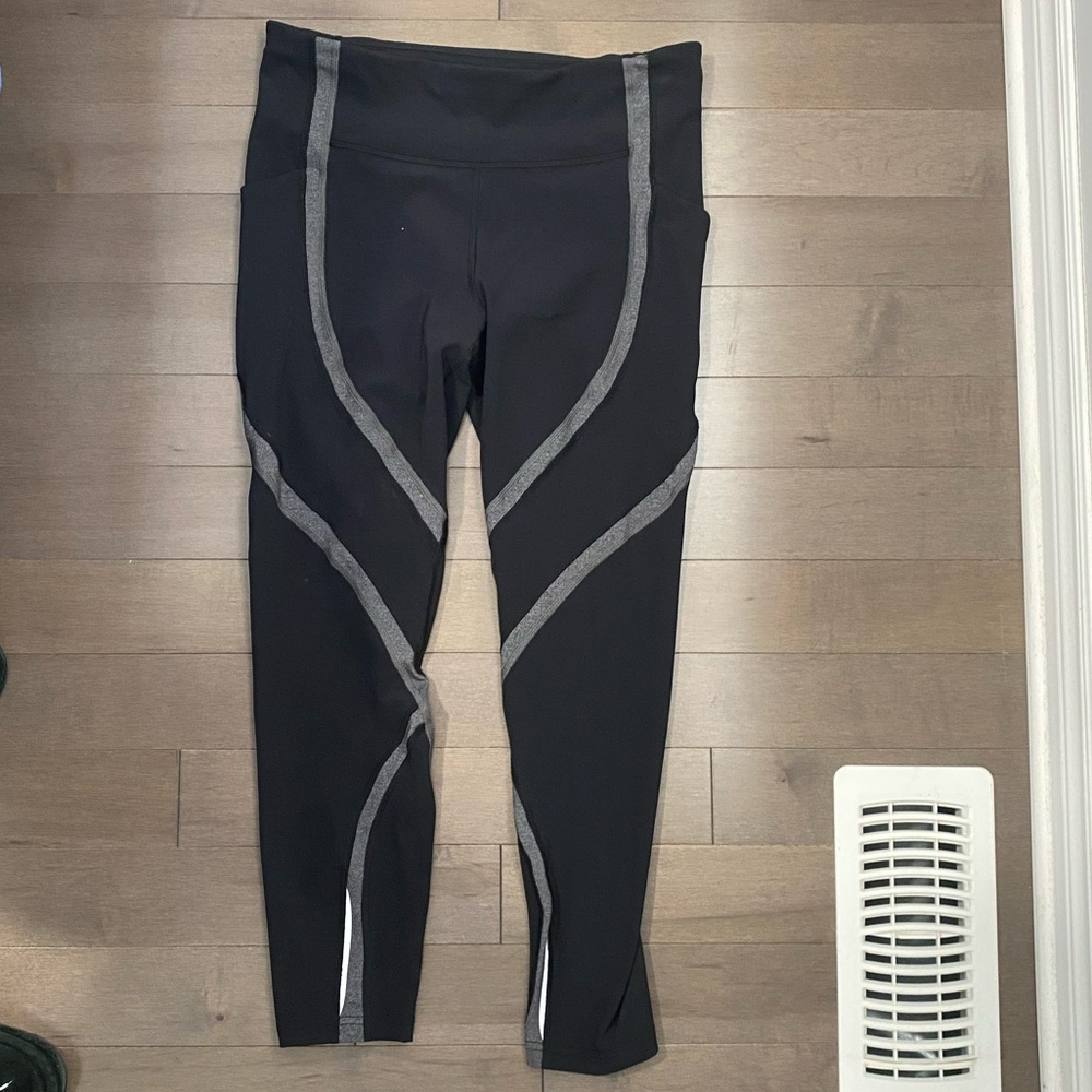 Lululemon leggings with side and back pockets. Size 10 black with gray design.